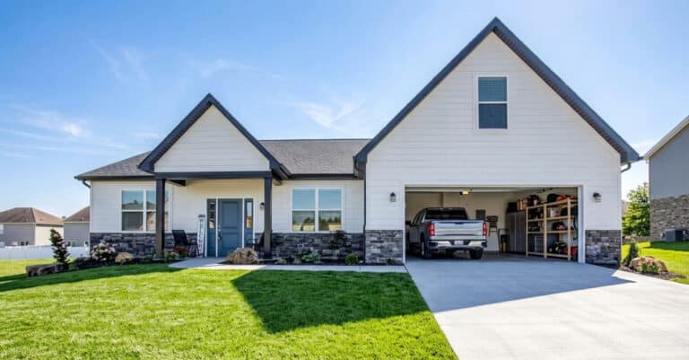 Modern home with attractive curb appeal and a spacious garage on a clear day.