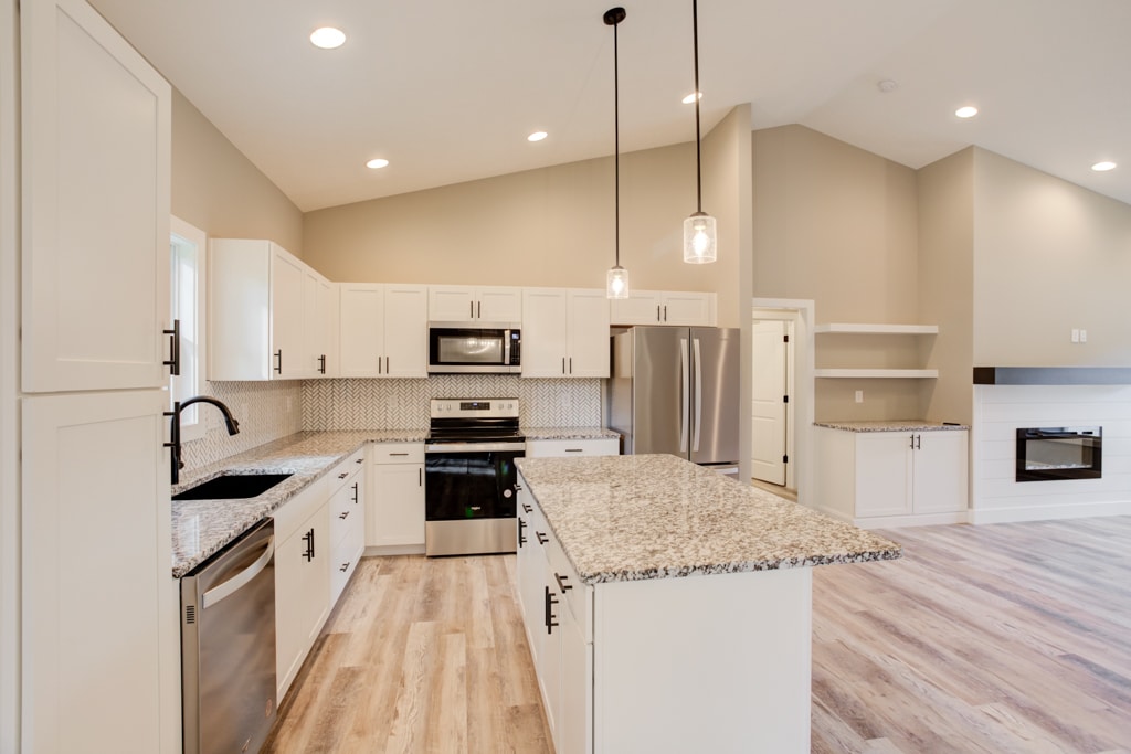 Spacious kitchen featuring granite countertops and modern appliances in a stylish layout.