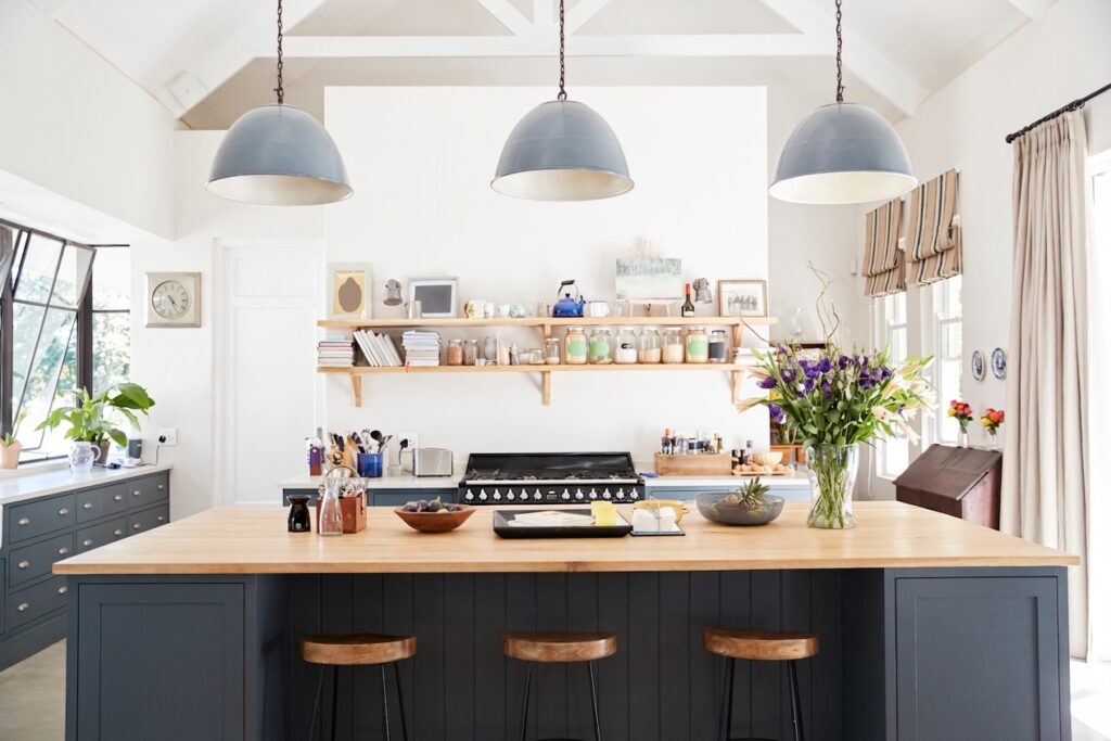 Stylish modern kitchen with island, open layout, and elegant lighting fixtures.