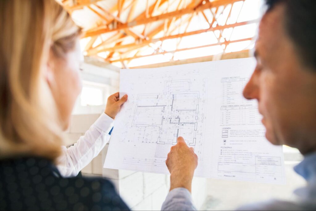 Reviewing a detailed floor plan for architectural design and construction project.
