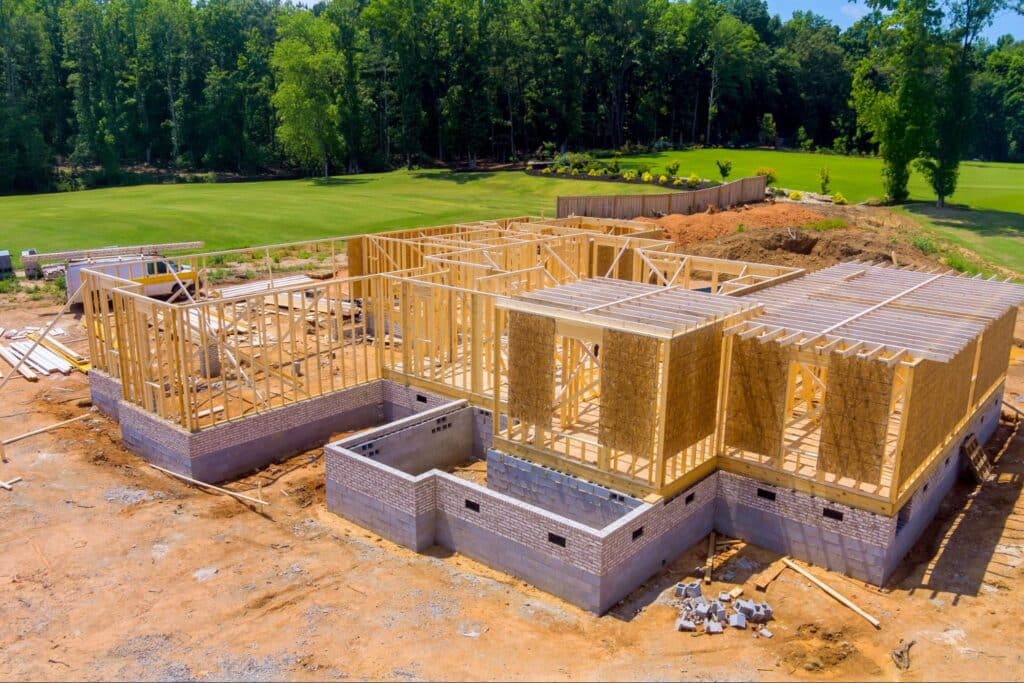 New residential construction site showcasing wooden framing and foundation work.