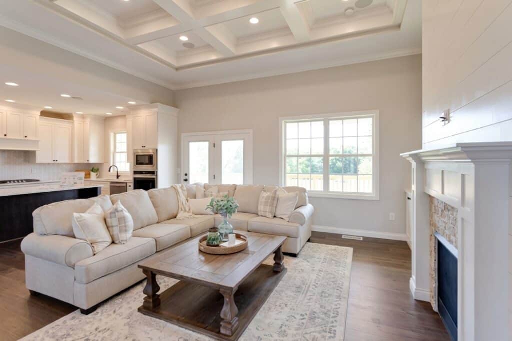 Spacious cozy living room with a sectional sofa, fireplace, and natural light.