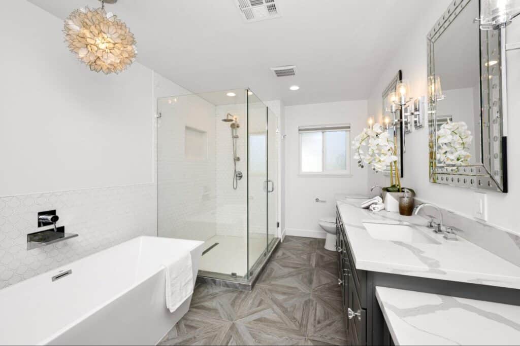 Elegant modern bathroom design featuring a sleek tub and stylish glass shower enclosure.