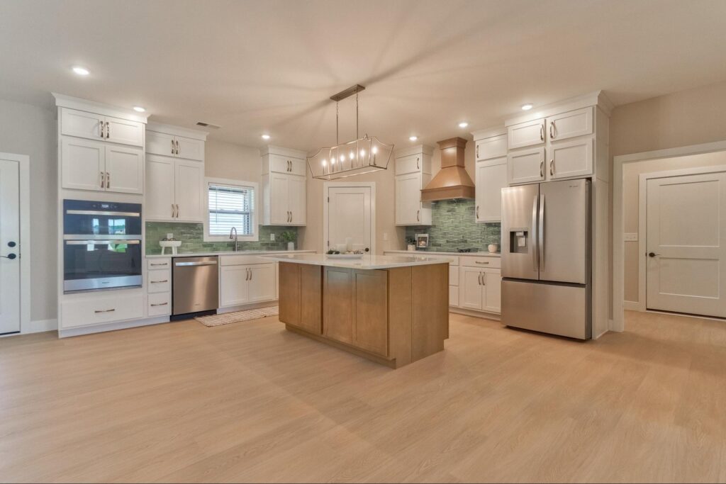 Stylish modern kitchen featuring sleek cabinetry, stainless steel appliances, and elegant lighting.