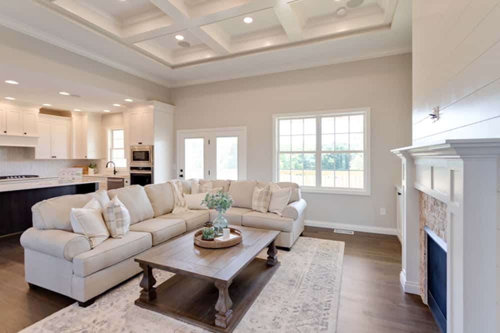 Cozy living room with a sectional sofa, coffee table, and natural light.