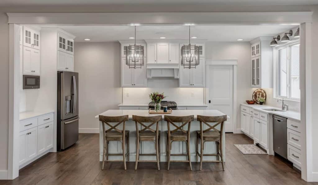 Sleek modern kitchen design with white cabinetry and stylish pendant lighting.