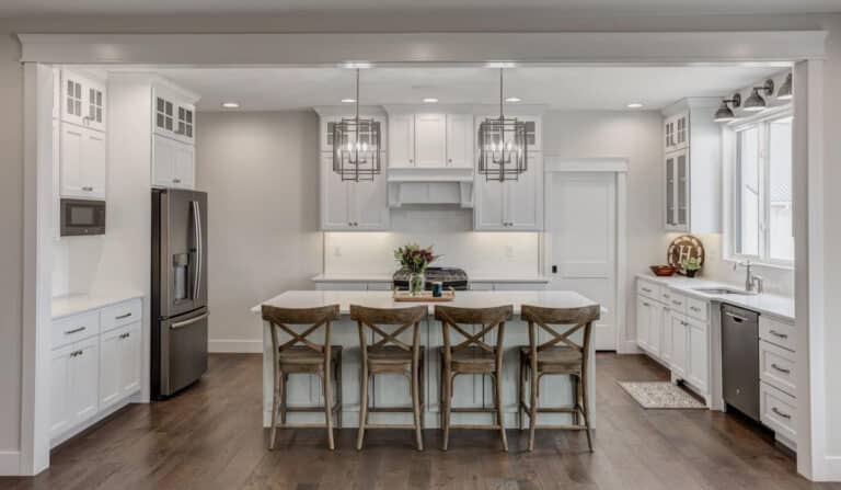 Sleek modern kitchen design with white cabinetry and stylish pendant lighting.