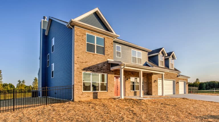 Stunning new home exterior with modern design and spacious layout in a scenic setting.
