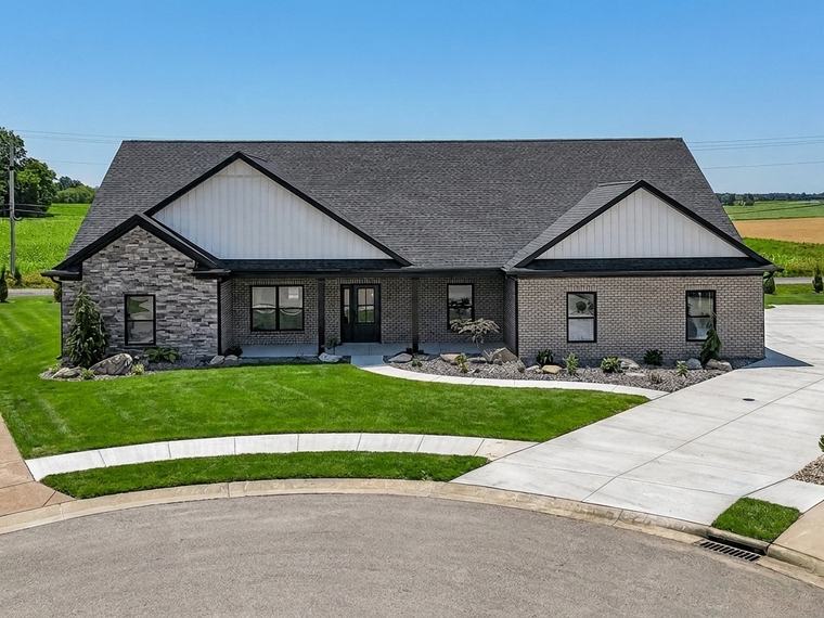 Whitfield Court, a Reinbrecht ranch in stone and dark board-and-batten