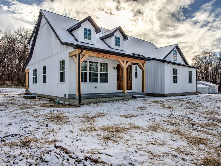 Upper Mt. Vernon Rd, a white Reinbrecht farmhouse with a timber-post porch